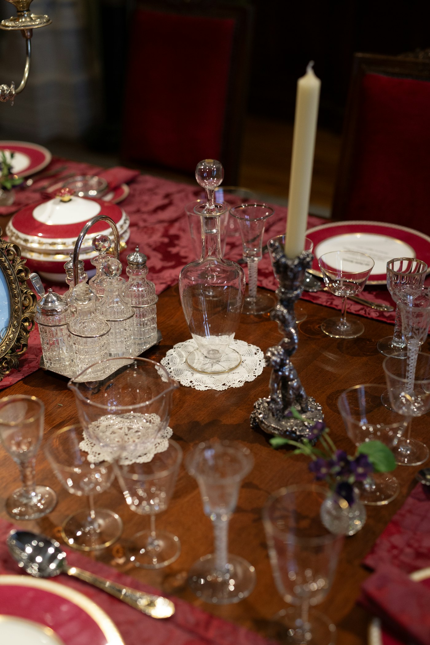 Elegant table setting with crystal glassware and red accents