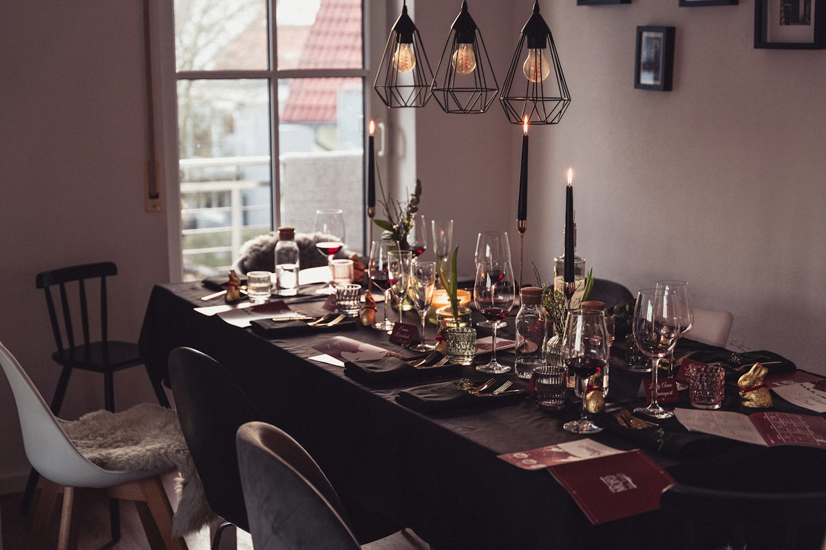 Long dining table set with glasses and place settings
