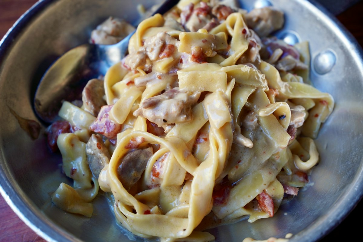 Fresh tagliatelle tossed with slow-cooked meat sauce