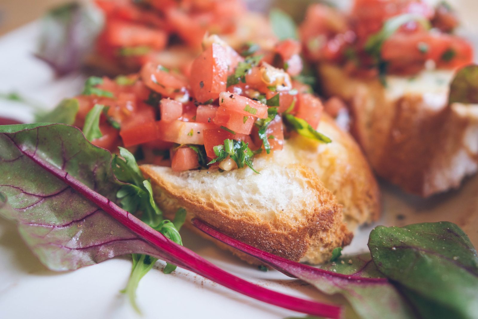 Bruschetta topped with chopped tomatoes and herbs